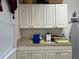 Well-lit laundry room with cabinets and counter space for folding at 5030 Haywood Ruffin Rd, St Cloud, FL 34771