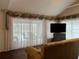 Living room features sliders overlooking the pool and a view to the backyard at 5030 Haywood Ruffin Rd, St Cloud, FL 34771
