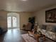 Living room featuring hardwood floors, a floral sofa, and a cozy armchair at 5030 Haywood Ruffin Rd, St Cloud, FL 34771