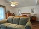 Main bedroom with a comfy couch and ceiling fan at 5030 Haywood Ruffin Rd, St Cloud, FL 34771
