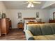 Main bedroom with a king-size bed, sitting area, and wood floors at 5030 Haywood Ruffin Rd, St Cloud, FL 34771