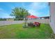Relaxing backyard with patio furniture under an umbrella at 5283 Bracks Landing Dr Dr, St Cloud, FL 34771
