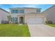 Two-story house with a two-car garage and landscaped lawn at 5283 Bracks Landing Dr Dr, St Cloud, FL 34771