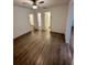 Spacious bedroom with wood-look floors and access to bathroom at 5920 Nw 65Th St, Ocala, FL 34482