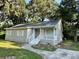 Tan house with white trim, steps, and a walkway at 5920 Nw 65Th St, Ocala, FL 34482