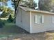 Side view of house showcasing tan siding, white shutters, and landscaping at 5920 Nw 65Th St, Ocala, FL 34482