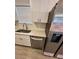 White kitchen cabinets, quartz countertops, and stainless steel dishwasher at 5920 Nw 65Th St, Ocala, FL 34482