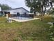 Backyard pool with safety fence is surrounded by a concrete deck and grassy yard, offering outdoor relaxation at 602 Caddy Dr, Kissimmee, FL 34759