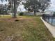 Large backyard featuring partial views of a pool with safety fence and a storage shed in the back at 602 Caddy Dr, Kissimmee, FL 34759