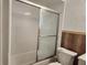 Bathroom featuring a shower/tub combination with sliding glass door at 602 Caddy Dr, Kissimmee, FL 34759