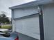 Garage door and exterior wall, showcasing the home's design and attached two-car garage at 602 Caddy Dr, Kissimmee, FL 34759