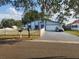 Charming single-Gathering home with a manicured lawn, white picket fence, and a spacious two-car garage at 602 Caddy Dr, Kissimmee, FL 34759