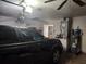 An oversized garage provides ample space for parking and storage with mechanicals and shelving at 602 Caddy Dr, Kissimmee, FL 34759