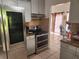 Kitchen featuring stainless steel appliances, gray cabinetry and tiled backsplash at 602 Caddy Dr, Kissimmee, FL 34759