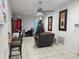 Living room featuring tile floors, a brick fireplace, and a Christmas tree, creating a cozy atmosphere at 602 Caddy Dr, Kissimmee, FL 34759