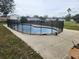 An above-ground pool surrounded by a black safety fence at 602 Caddy Dr, Kissimmee, FL 34759