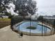 Backyard in ground pool featuring a safety fence and concrete deck at 602 Caddy Dr, Kissimmee, FL 34759