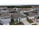 Aerial view of a residential neighborhood with houses and solar panels at 606 Tortugas St, Haines City, FL 33844