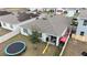 Aerial view of a backyard with a trampoline and slide at 606 Tortugas St, Haines City, FL 33844