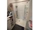 Bathroom with a shower and storage shelves at 606 Tortugas St, Haines City, FL 33844