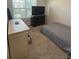 Simple bedroom with a bed, dresser, and TV at 606 Tortugas St, Haines City, FL 33844