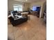Living room with sectional sofa and large TV at 606 Tortugas St, Haines City, FL 33844
