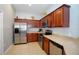 Kitchen with stainless steel appliances and wood cabinets at 7122 Forty Banks Rd # 39A, Harmony, FL 34773