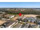 An aerial view of the home and surrounding neighborhood near a golf course and wooded areas at 733 Desert Mountain Ct, Reunion, FL 34747