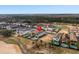 Aerial view of luxury homes featuring pools, lush landscaping, and a golf course backdrop at 733 Desert Mountain Ct, Reunion, FL 34747
