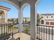 Balcony featuring arched columns and neighborhood street views at 733 Desert Mountain Ct, Reunion, FL 34747