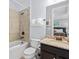 Bathroom features a granite countertop, white ceramic tile walls, and a tub-shower combo at 733 Desert Mountain Ct, Reunion, FL 34747