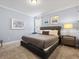 Comfortable bedroom with a tufted headboard, carpeted floors, and decorative wall art at 733 Desert Mountain Ct, Reunion, FL 34747