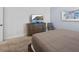 Bedroom with a dresser, television, carpeting, and a neutral color scheme at 733 Desert Mountain Ct, Reunion, FL 34747
