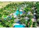 Aerial view of a large community pool area with lush landscaping and resort-style amenities at 733 Desert Mountain Ct, Reunion, FL 34747