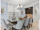 Elegant dining room with a chandelier, window, and a table seating six upholstered chairs at 733 Desert Mountain Ct, Reunion, FL 34747