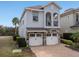 Charming two-story home features a stone accents, two-car garage, and manicured landscaping at 733 Desert Mountain Ct, Reunion, FL 34747