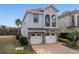 Beautiful two-story home with a stone-accented facade, a balcony, and a two-car garage at 733 Desert Mountain Ct, Reunion, FL 34747