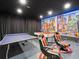 This game room features bold decor, a ping pong table, a pool table, and comfortable chairs at 733 Desert Mountain Ct, Reunion, FL 34747