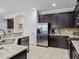 Modern kitchen with stainless steel appliances and granite countertops at 733 Desert Mountain Ct, Reunion, FL 34747