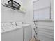 Bright laundry room with full size washer and dryer and plenty of storage space on the shelves at 733 Desert Mountain Ct, Reunion, FL 34747