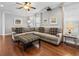 Spacious living room with a large sectional couch, hardwood floors, and modern decor at 733 Desert Mountain Ct, Reunion, FL 34747