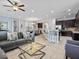 Open-concept living room featuring tile floors and an adjoining eat-in kitchen at 733 Desert Mountain Ct, Reunion, FL 34747