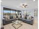 Bright and airy living room with a large sectional sofa and tile flooring at 733 Desert Mountain Ct, Reunion, FL 34747