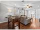 Inviting living room features a foosball table, plush grey sofa, and rich hardwood flooring at 733 Desert Mountain Ct, Reunion, FL 34747