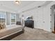 Spacious main bedroom features a TV, large window, and access to an outdoor patio at 733 Desert Mountain Ct, Reunion, FL 34747