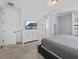 Bright main bedroom with carpet flooring, tv on dresser, and french doors to balcony at 733 Desert Mountain Ct, Reunion, FL 34747