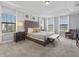 Relaxing main bedroom features a tufted headboard, soft carpet, and ample natural light at 733 Desert Mountain Ct, Reunion, FL 34747