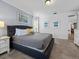 Spacious main bedroom featuring carpet flooring, a large bed, and wall art for a relaxing atmosphere at 733 Desert Mountain Ct, Reunion, FL 34747