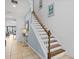 Staircase with wood and white accents, leading to the upper level of the home at 733 Desert Mountain Ct, Reunion, FL 34747
