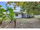 Backyard view of home with lush landscaping and screened patio at 8607 Tarragon Dr, Orlando, FL 32825
